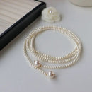 Este outono e inverno novo colar de corrente de suéter redondo, brilhante e quente branco Shijia pérola longa em camadas troude um charme feminino