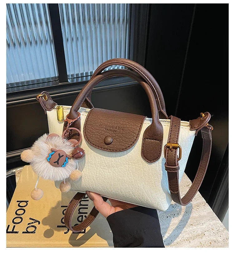 Bolsa crossbody de ombro de grande capacidade em formato de bolinho elegante para deslocamento no outono e inverno com design de bloco de cores
