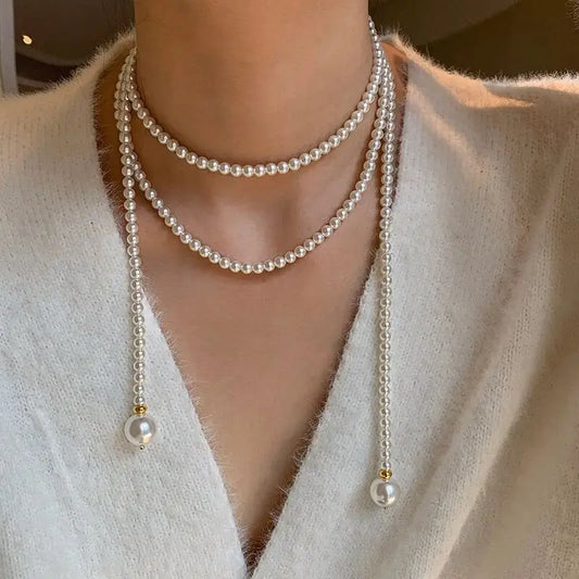 Este outono e inverno novo colar de corrente de suéter redondo, brilhante e quente branco Shijia pérola longa em camadas troude um charme feminino