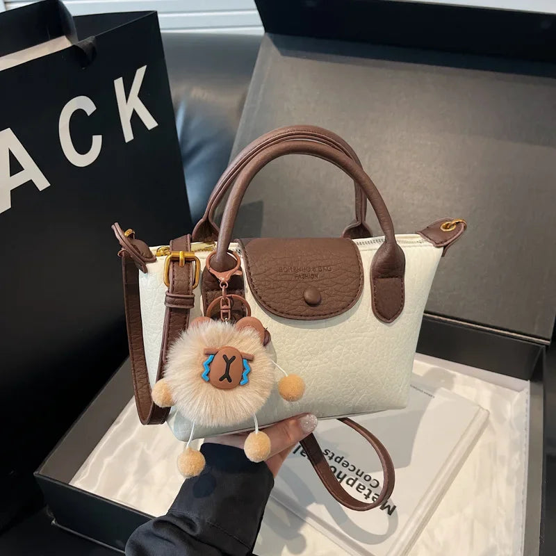 Bolsa crossbody de ombro de grande capacidade em formato de bolinho elegante para deslocamento no outono e inverno com design de bloco de cores