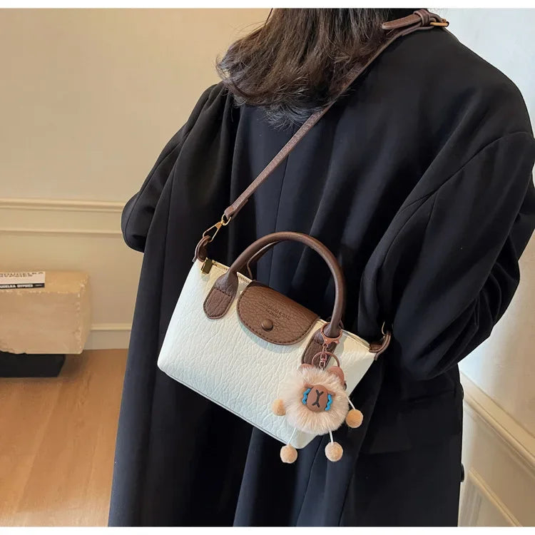 Bolsa crossbody de ombro de grande capacidade em formato de bolinho elegante para deslocamento no outono e inverno com design de bloco de cores