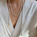 Este outono e inverno novo colar de corrente de suéter redondo, brilhante e quente branco Shijia pérola longa em camadas troude um charme feminino